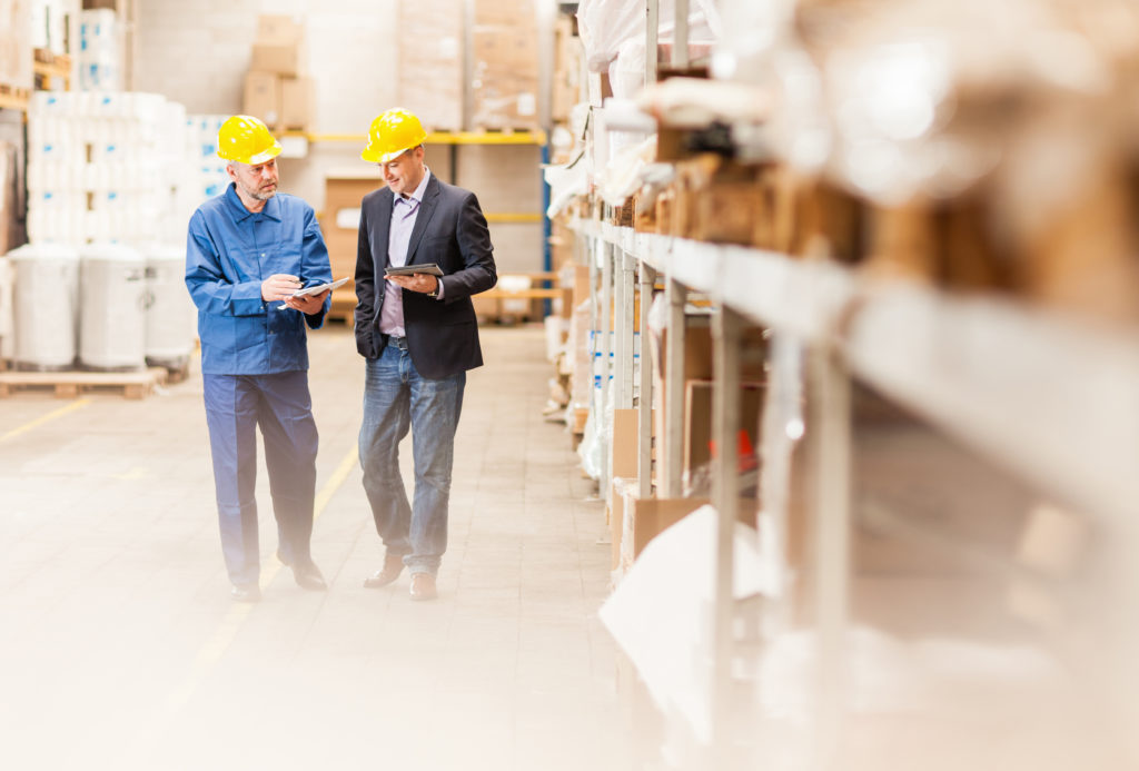 Quality of Earnings Report - Two men in warehouse