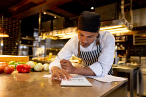 Chef in Restaurant Reviewing Financials