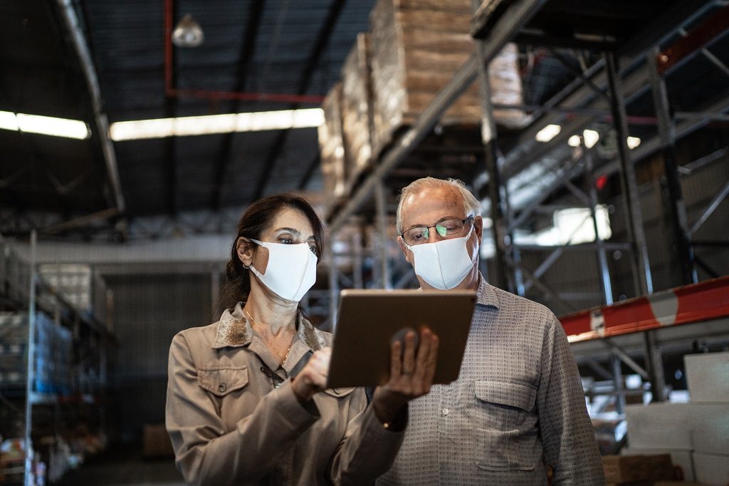 Employees in warehouse wearing masks